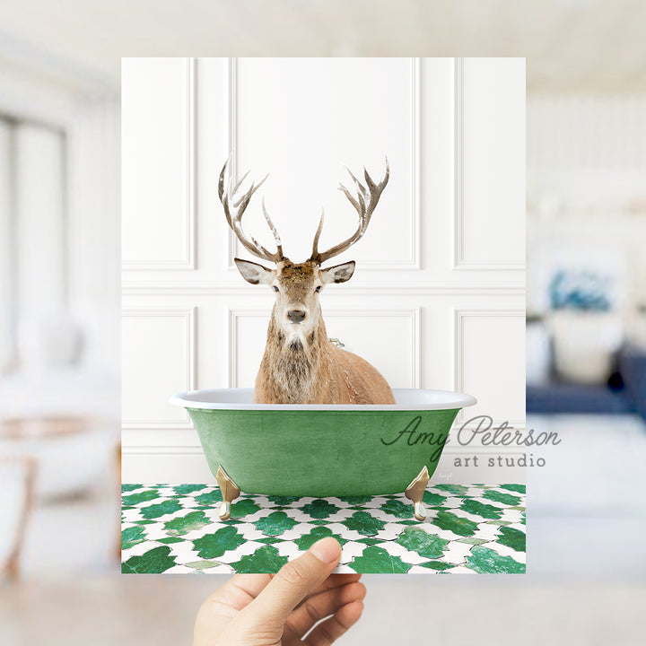 a hand holding a card with a deer in a bathtub