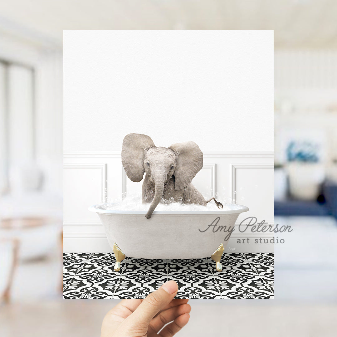 a person holding up a card with an elephant in a bathtub