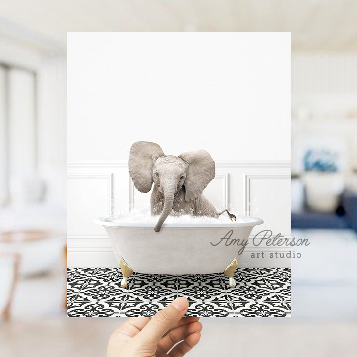 a person holding up a card with an elephant in a bathtub