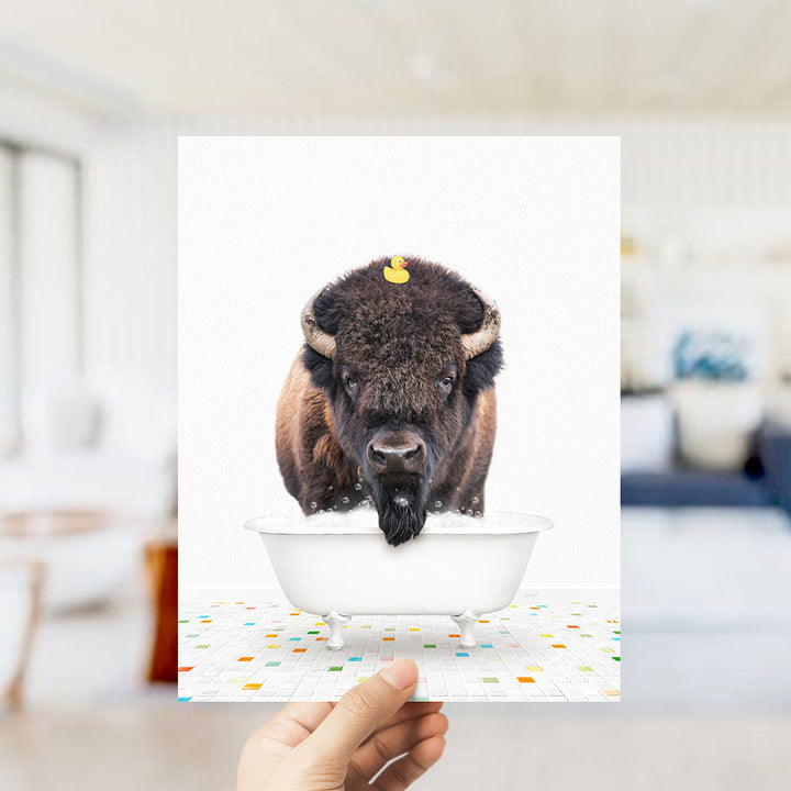A buffalo with a yellow rubber duck sitting in a bathtub.