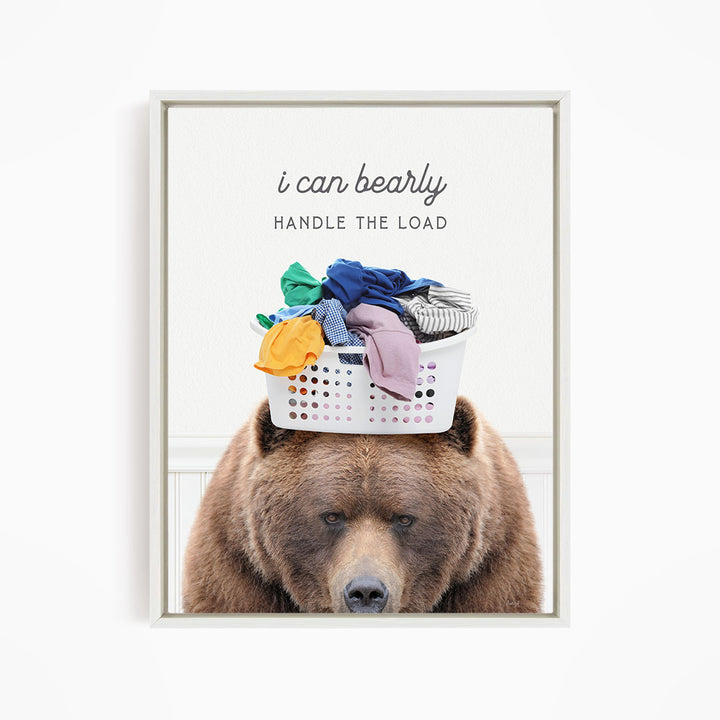 A brown bear sits in front of a laundry basket filled with clothes, with the text "I can bearly handle the load" written above the basket.