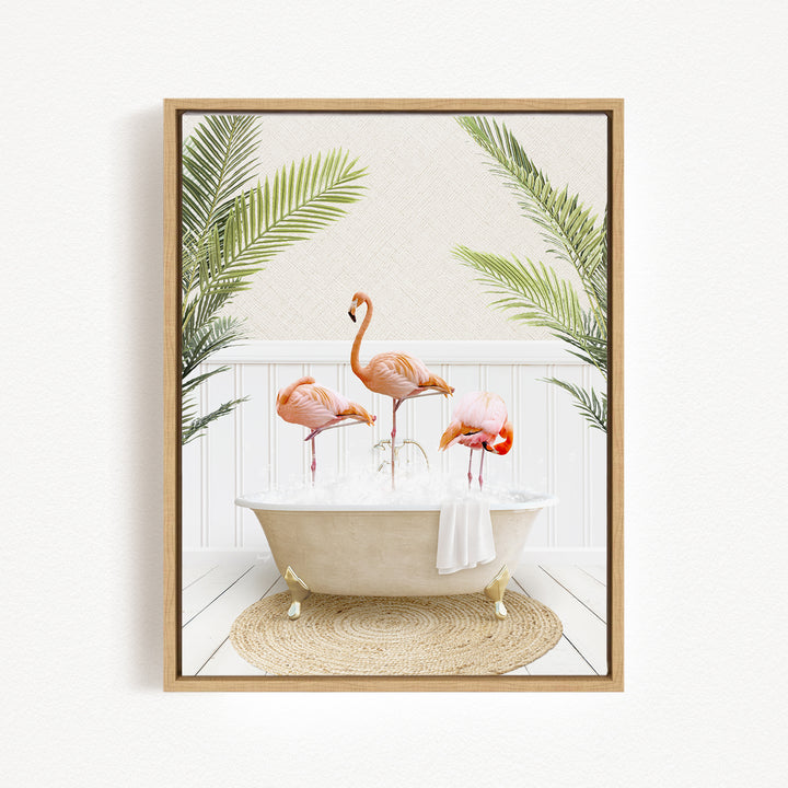 A framed image depicting three flamingos standing in a bathtub filled with water, surrounded by palm leaves.
