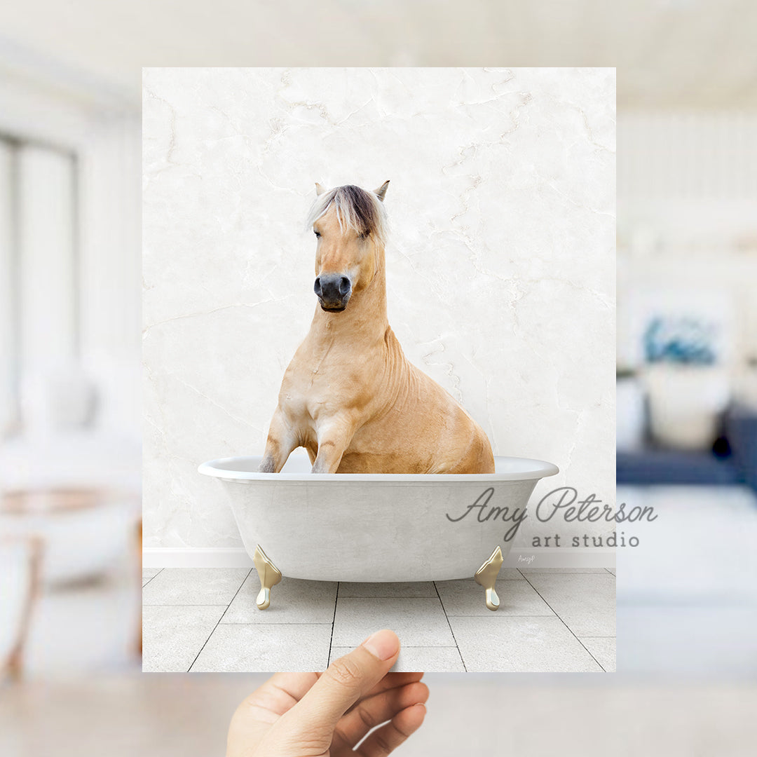 a hand holding a photo of a horse in a bathtub