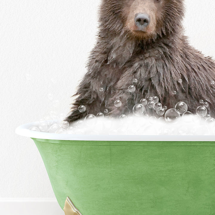 a brown bear sitting in a green bathtub filled with bubbles