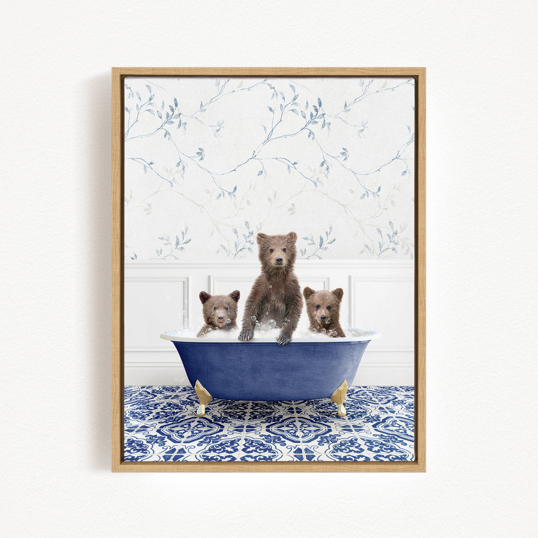 Three adorable brown bears sitting in a blue bathtub, with a floral patterned wall behind them.