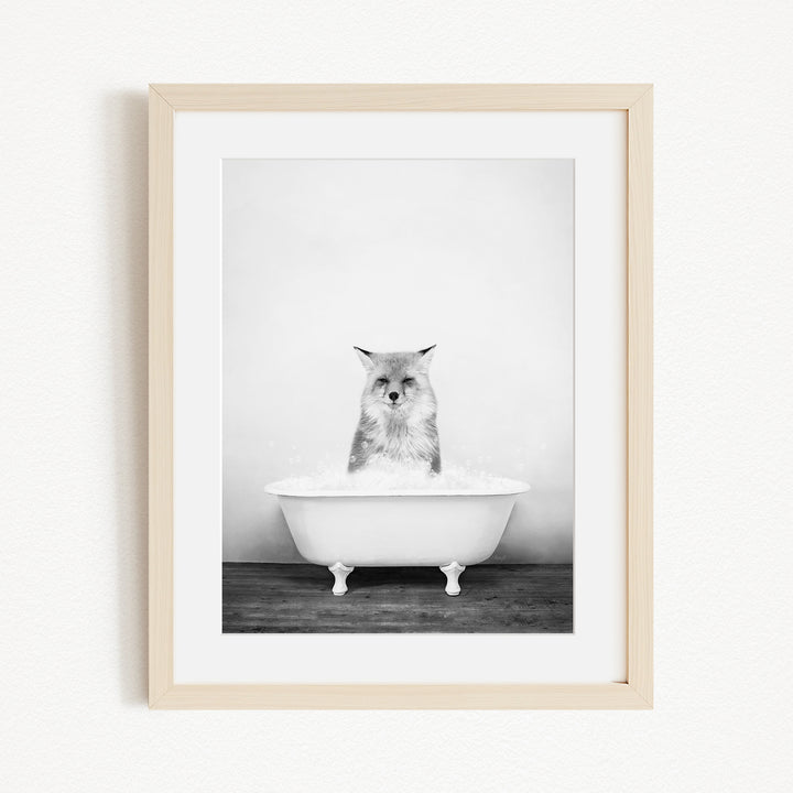 A cat sitting in a white bathtub filled with water, looking directly at the camera.