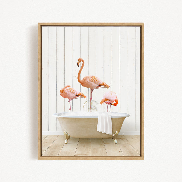 A framed image depicting three flamingos standing in a bathtub filled with water, creating a whimsical and playful scene.