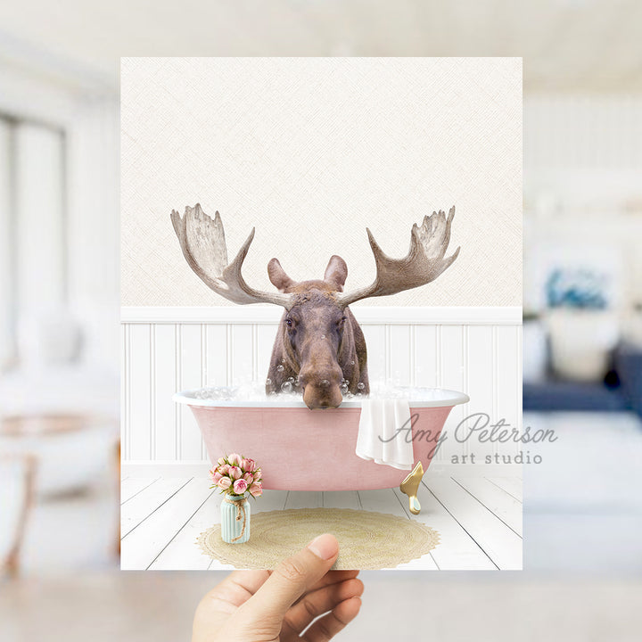 a person holding up a card with a picture of a moose in a bathtub