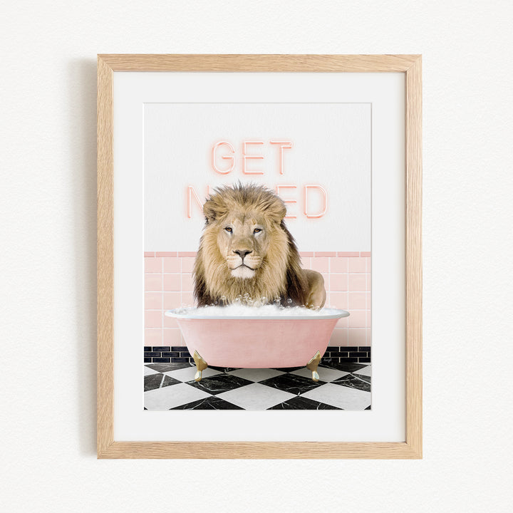 A framed image of a lion sitting in a pink bathtub with the text "GET NICKED" written on the wall behind it.