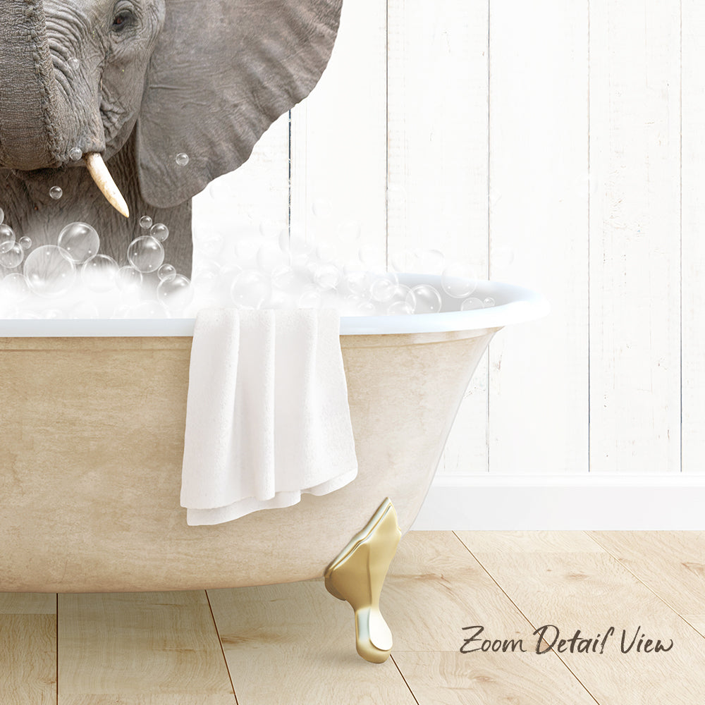 A large elephant is sitting in a bathtub filled with bubbles, with a towel draped over the side of the tub.