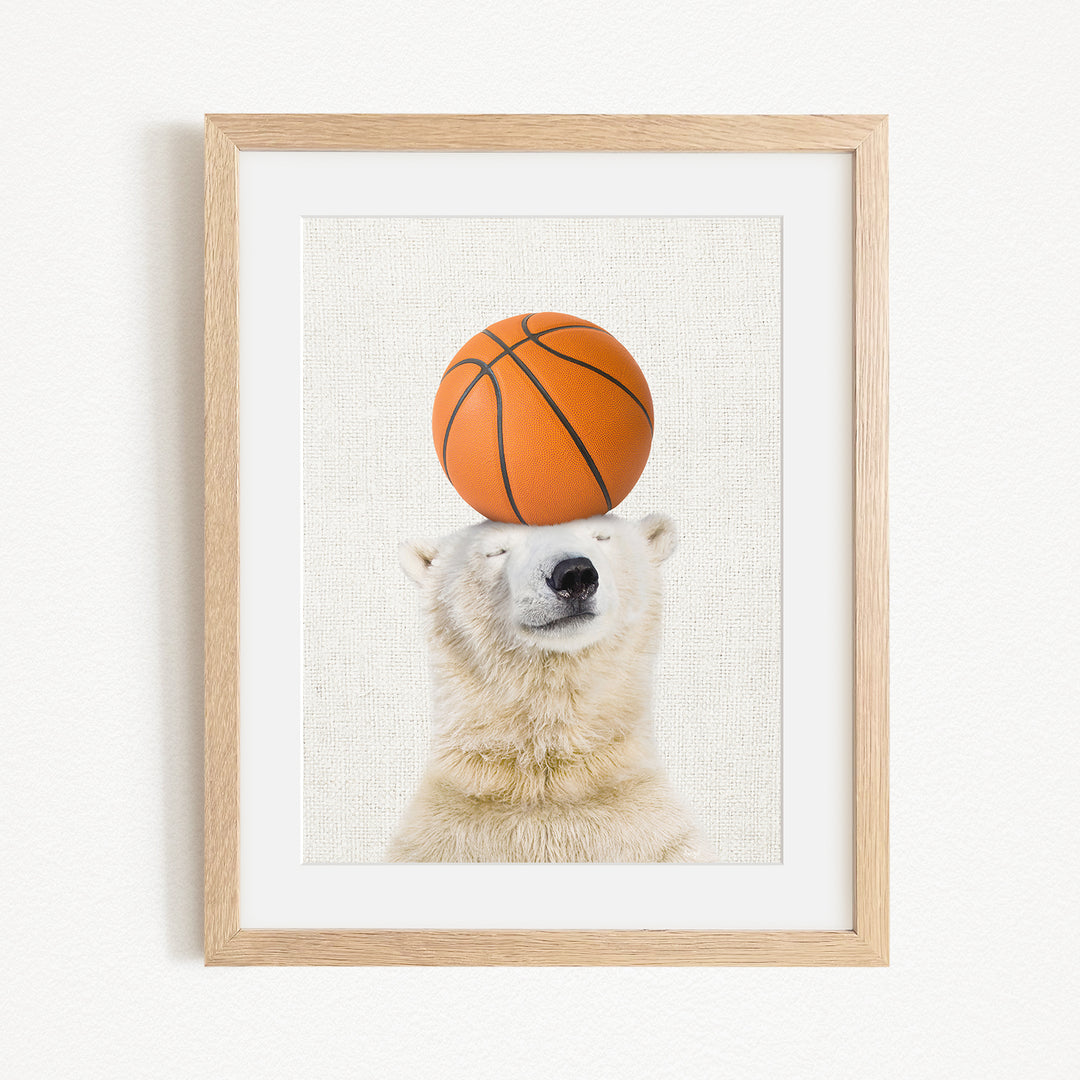A polar bear balancing a basketball on its head.