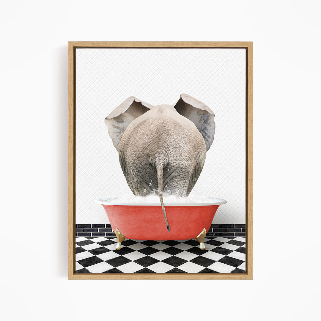 An elephant is standing in a red bathtub filled with water, with its trunk submerged in the water.