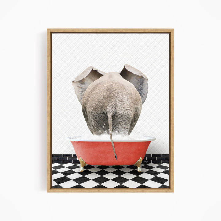 An elephant is standing in a red bathtub filled with water, with its trunk submerged in the water.