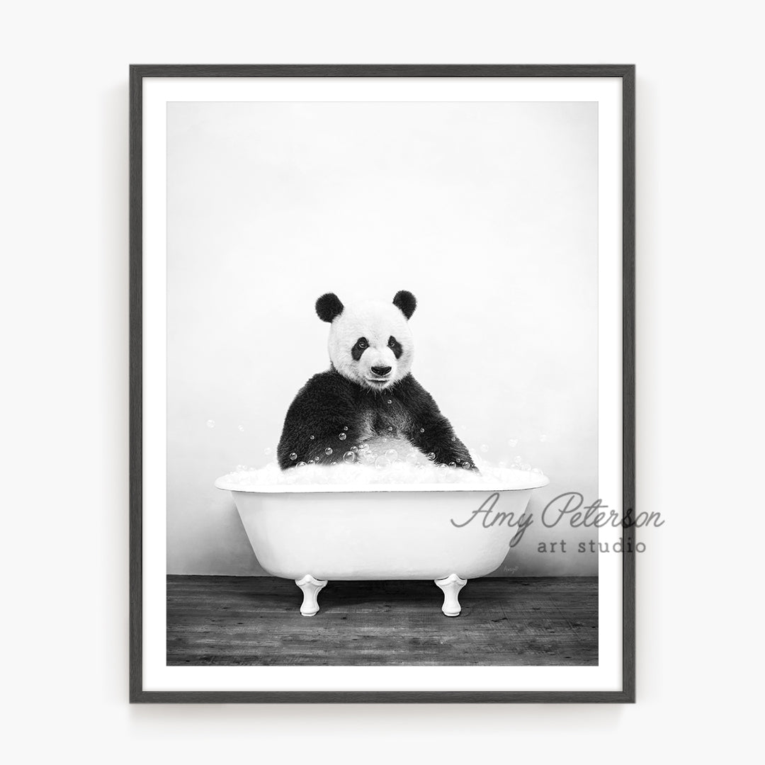 a black and white photo of a panda in a bathtub