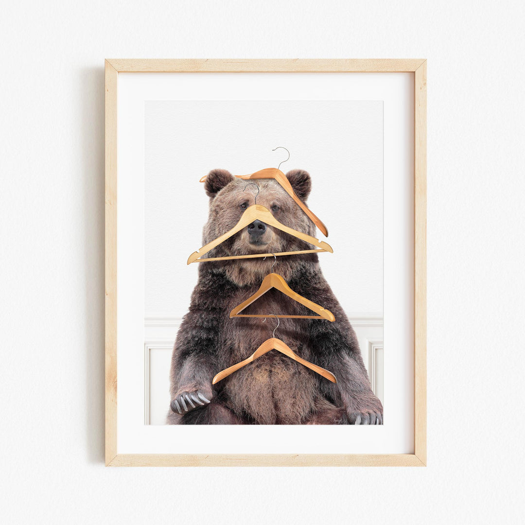 a picture of a bear with a pair of clothes hangers on it's