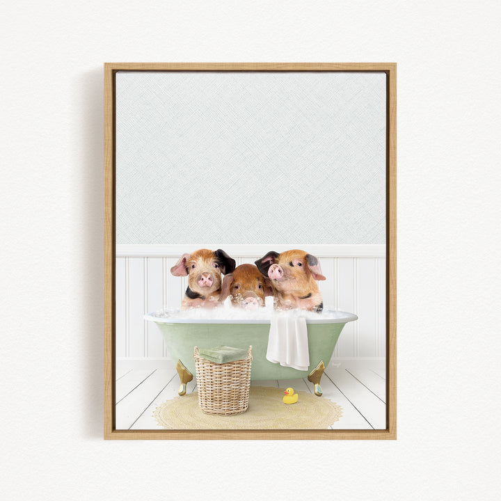 Three adorable pigs sitting in a green bathtub, with a basket of toys nearby.