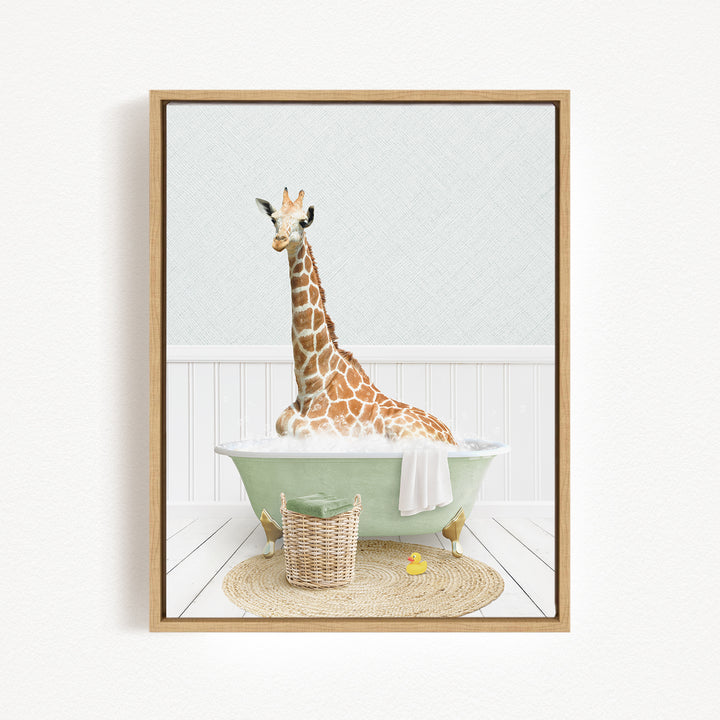 A giraffe sitting in a green bathtub filled with water, surrounded by a basket and a yellow rubber duck.