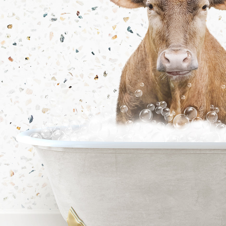 a cow sitting in a bathtub with bubbles all over it