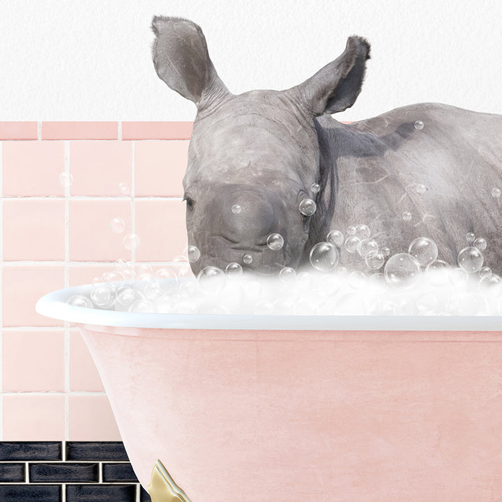 a rhino is taking a bath in a pink bathtub