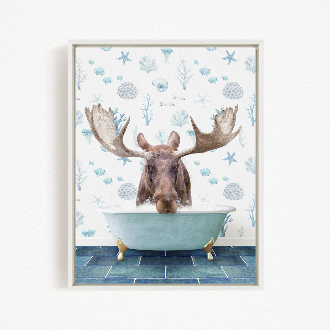 A moose with large antlers is sitting in a bathtub, surrounded by a pattern of seashells and starfish on the wall behind it.