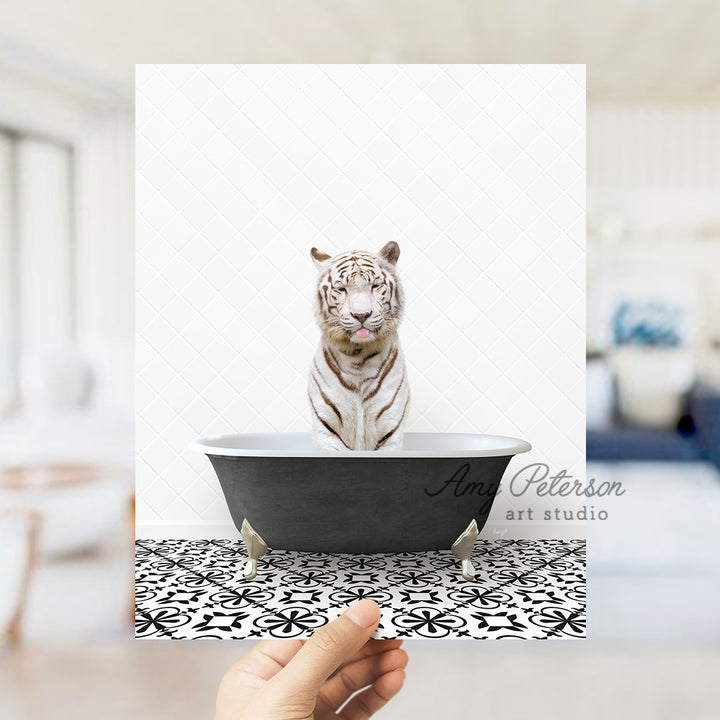 a white tiger sitting in a black bath tub