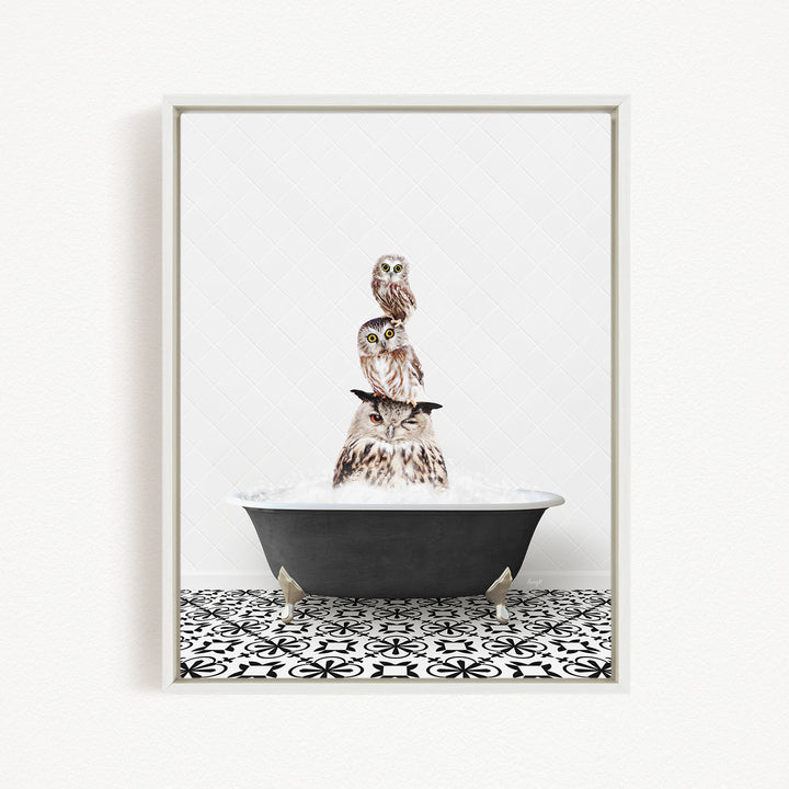 A framed image depicting three owls sitting in a bathtub filled with water, creating a whimsical and playful scene.