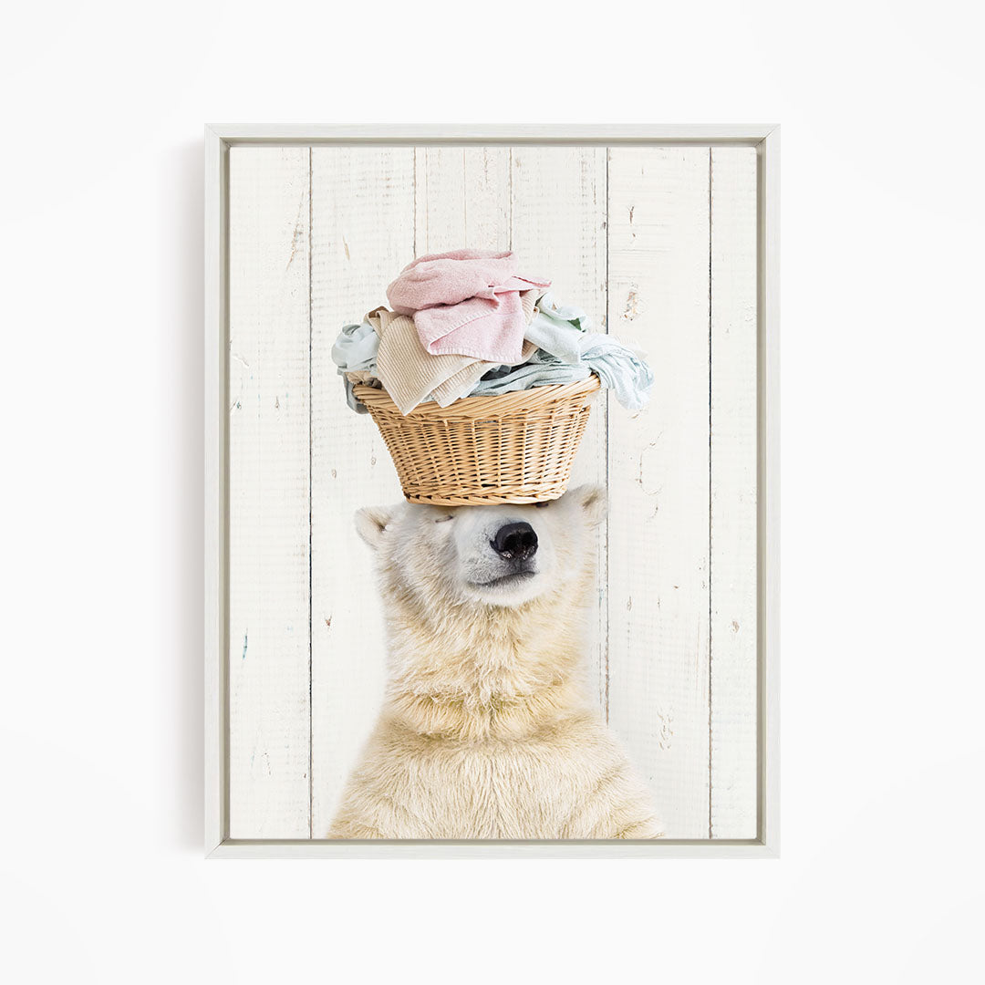 A polar bear balancing a basket of clothes on its head.