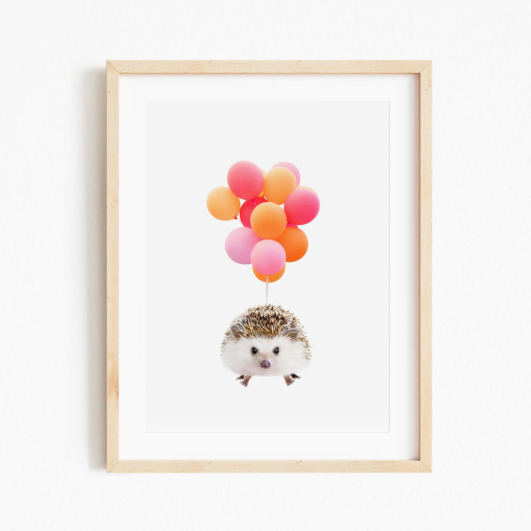 a hedge with a bunch of balloons floating above it