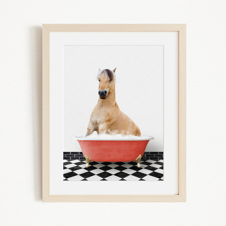 A light brown horse is sitting in a red bathtub filled with water, surrounded by a black and white checkered floor.