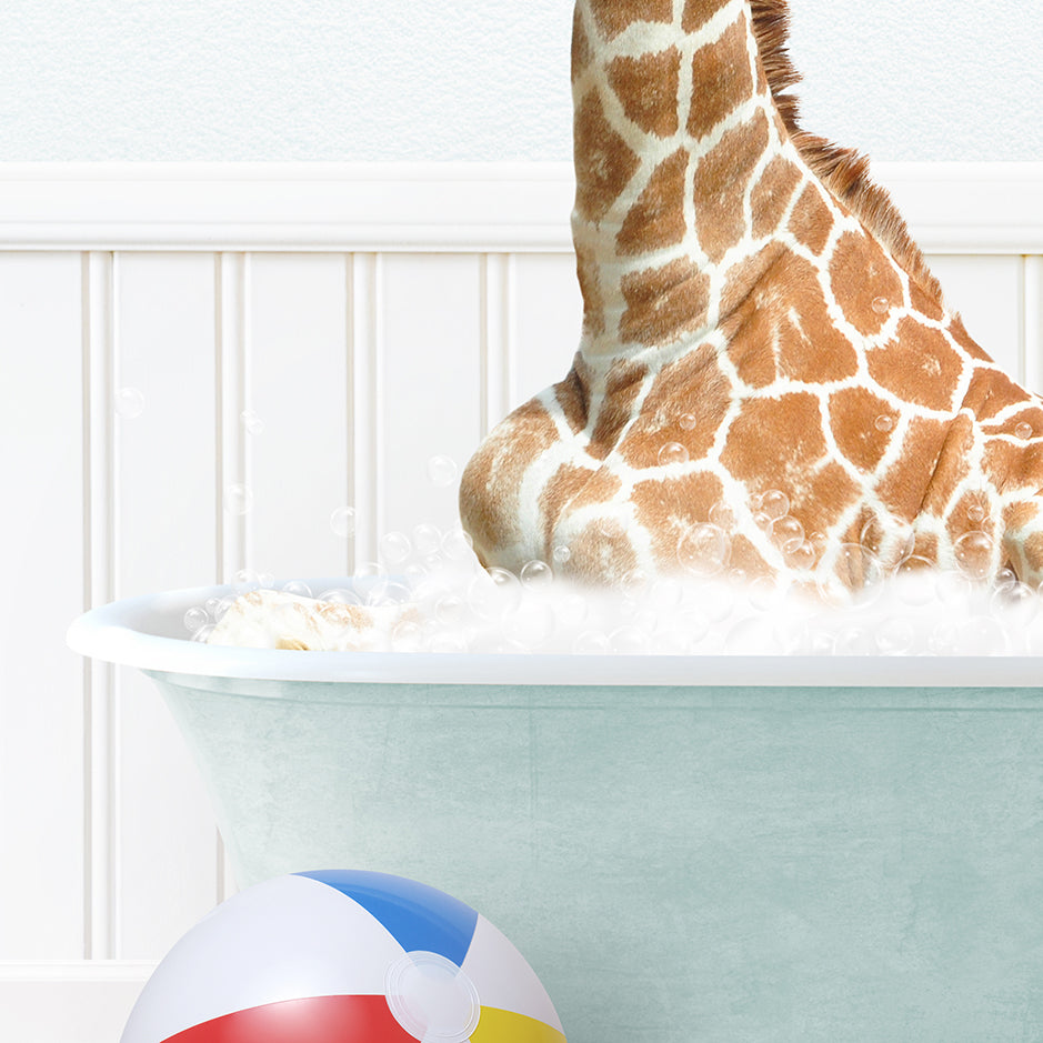 a giraffe sitting in a bathtub with a beach ball