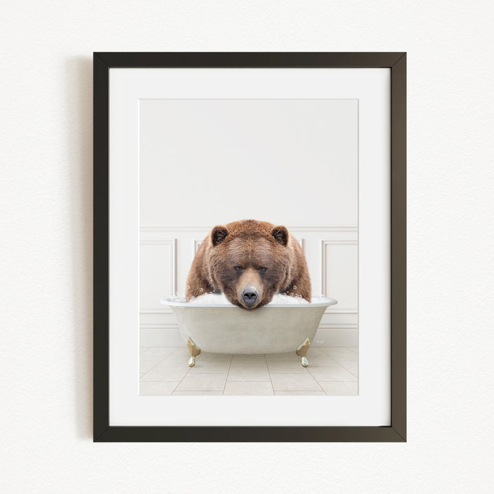 A brown bear is sitting in a white bathtub, appearing to be enjoying a relaxing bath.