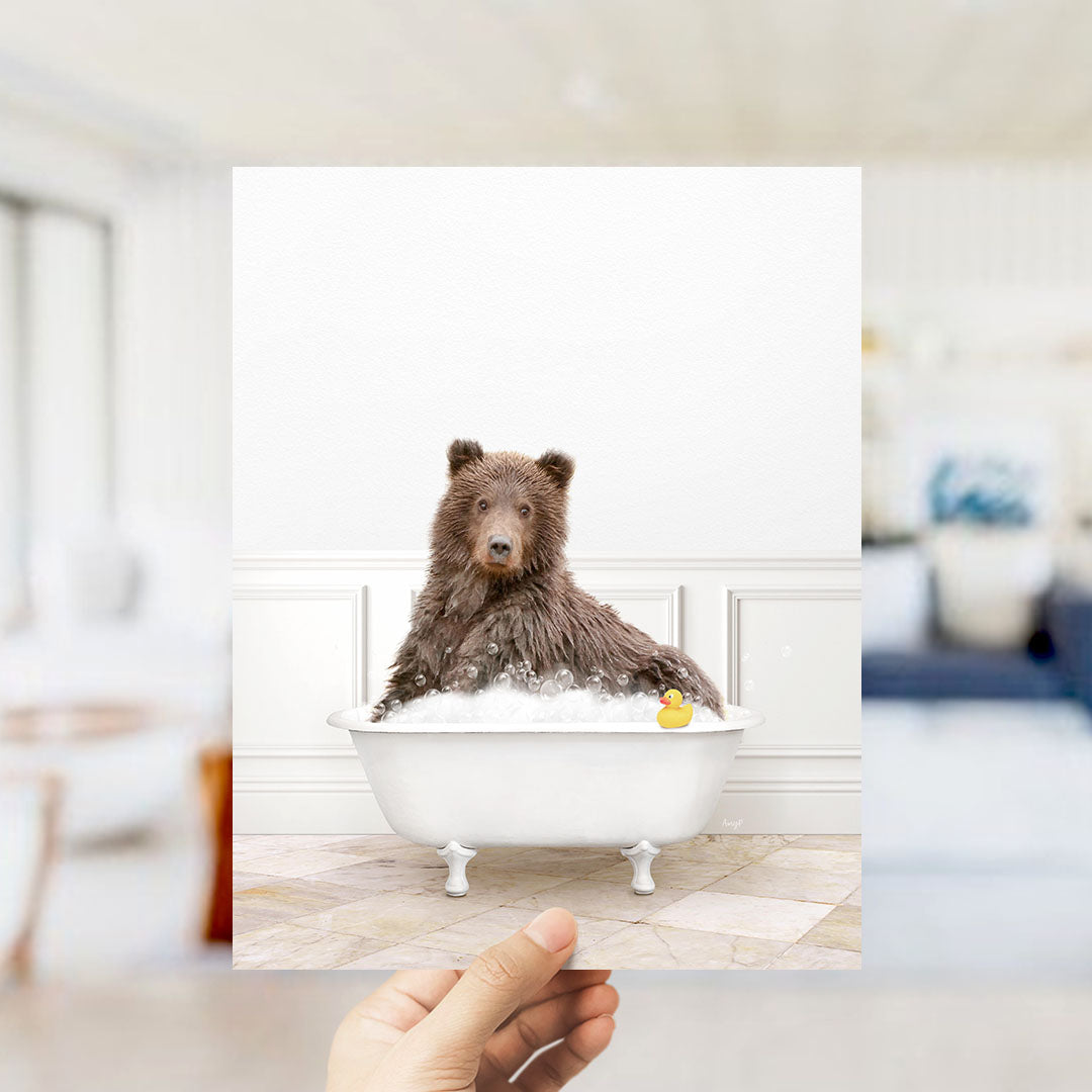 A brown bear sitting in a white bathtub filled with bubbles, with a yellow rubber duck floating nearby.