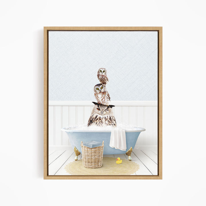 A framed image depicting a group of owls sitting in a bathtub filled with water, with a yellow rubber duck floating nearby.