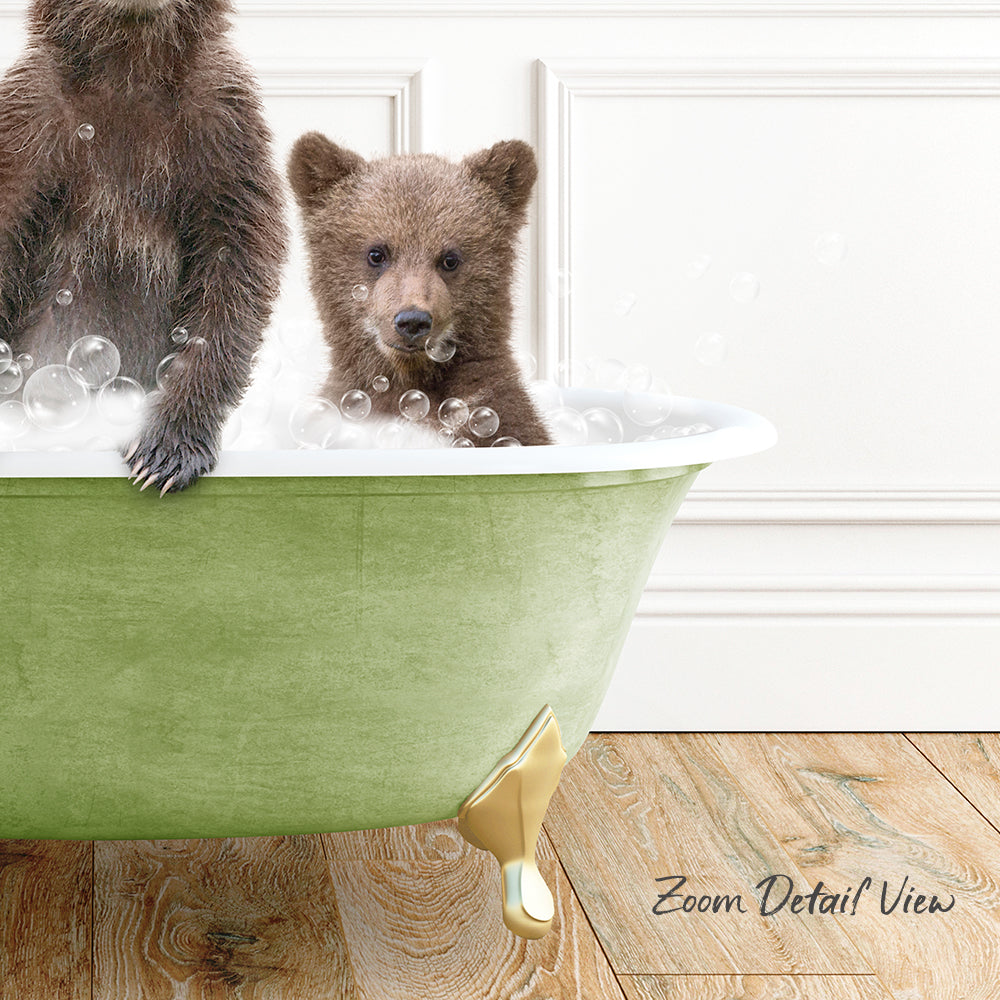 A baby bear sitting in a green bathtub filled with bubbles, with another bear standing next to it.