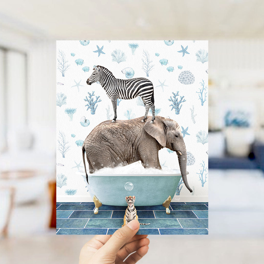 A hand holds up a collage of an elephant and a zebra standing in a bathtub, with a small tiger figurine nearby.