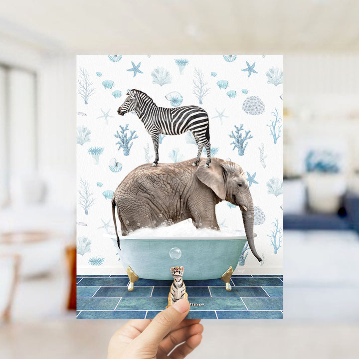 A hand holds up a collage of an elephant and a zebra standing in a bathtub, with a small tiger figurine nearby.