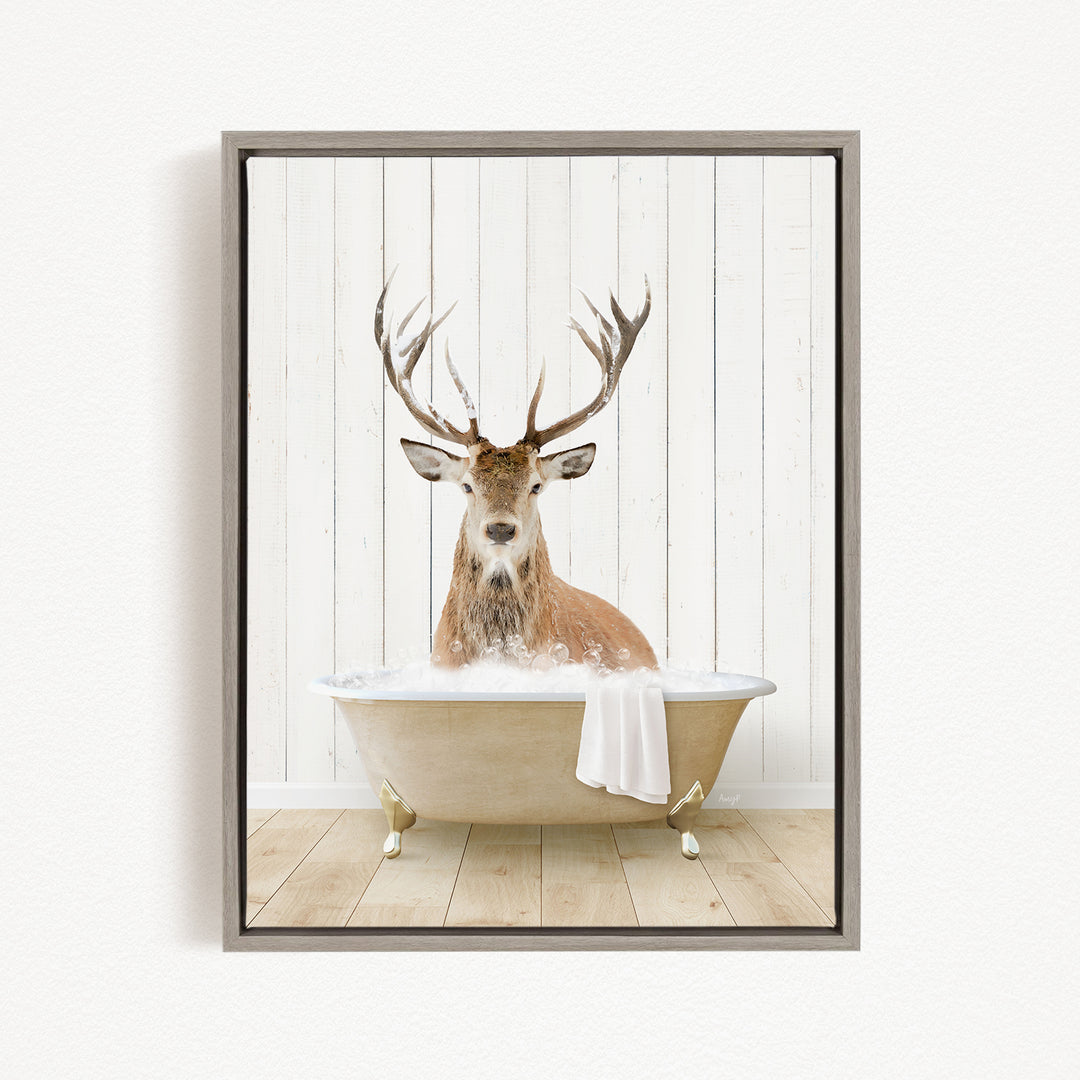 A deer with large antlers is sitting in a bathtub filled with water, creating a whimsical and unexpected scene.