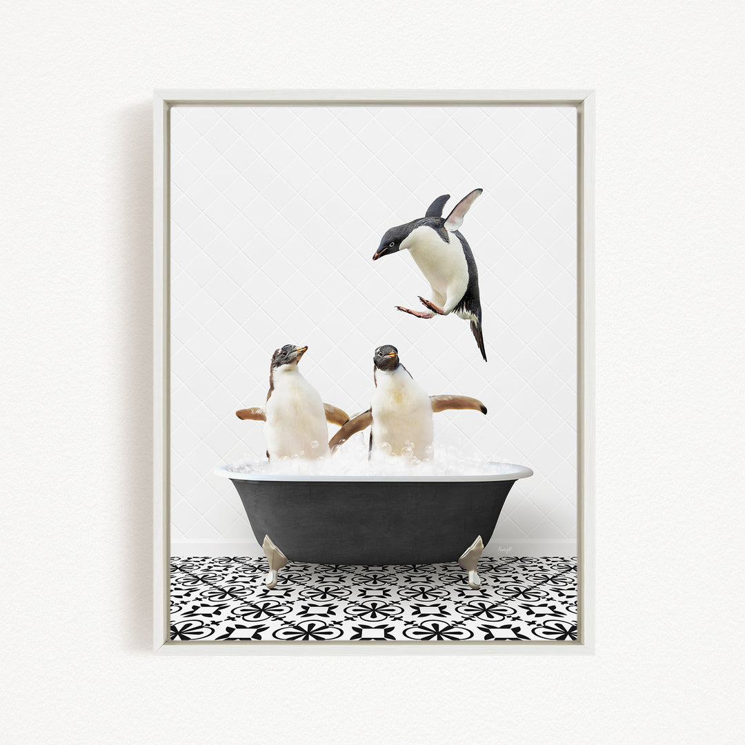 A framed image depicting two penguins sitting in a bathtub, with one penguin flying towards the other.