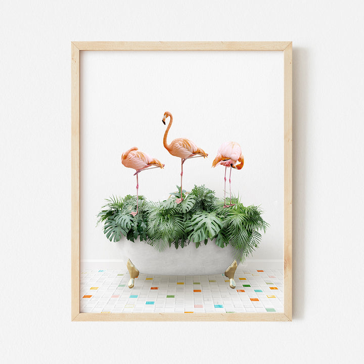 three flamingos in a bathtub with plants in it