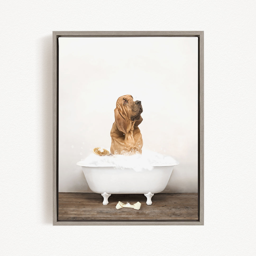 A brown dog standing in a white bathtub filled with water, with bubbles around it.