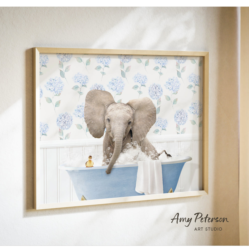 A framed image of an elephant sitting in a bathtub filled with bubbles, surrounded by a floral pattern.