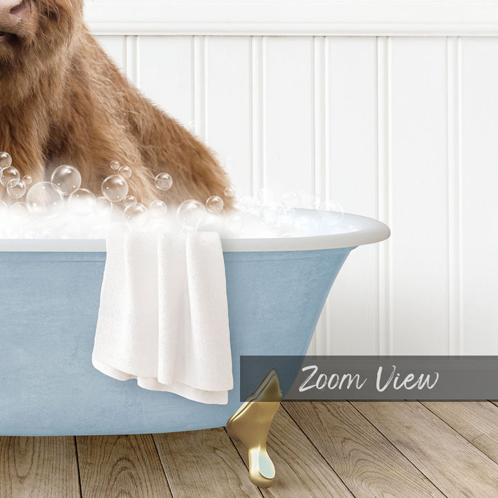 A brown dog is sitting in a blue bathtub filled with bubbles, with a white towel hanging on the side and a "Zoom View" label below the image.
