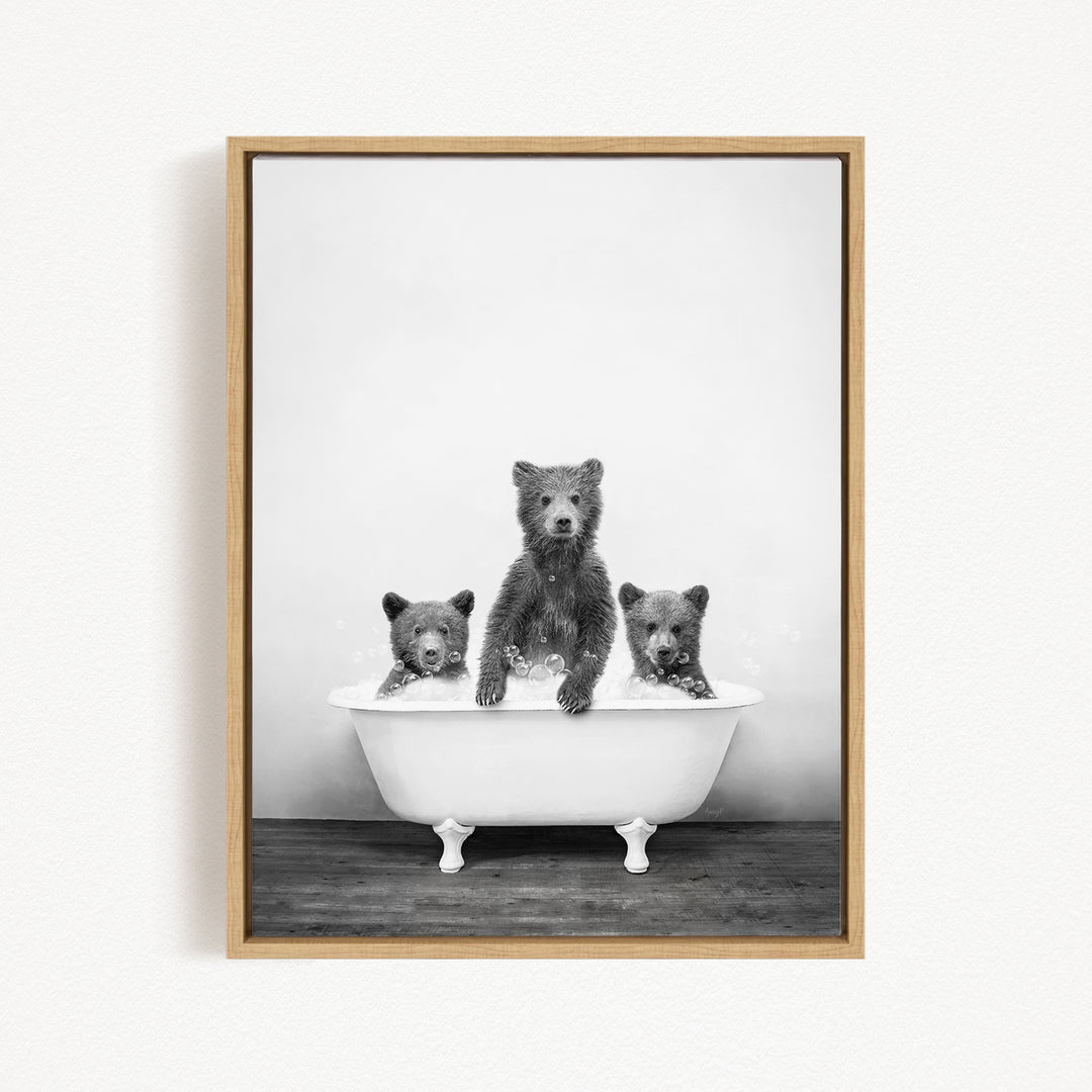 A black and white image of three bears sitting in a bathtub, with one bear sitting in the center and the other two bears sitting on either side.
