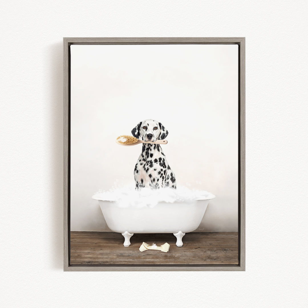 A Dalmatian dog sitting in a white bathtub, holding a yellow brush in its mouth.