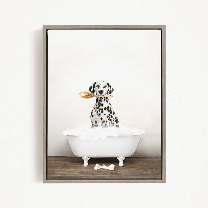 A Dalmatian dog sitting in a white bathtub, holding a yellow brush in its mouth.