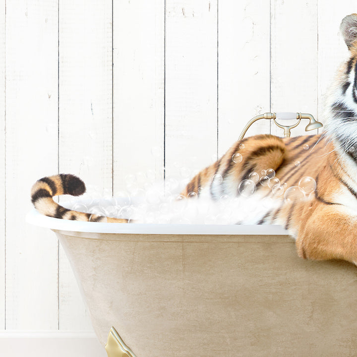 a stuffed tiger is sitting in a bathtub