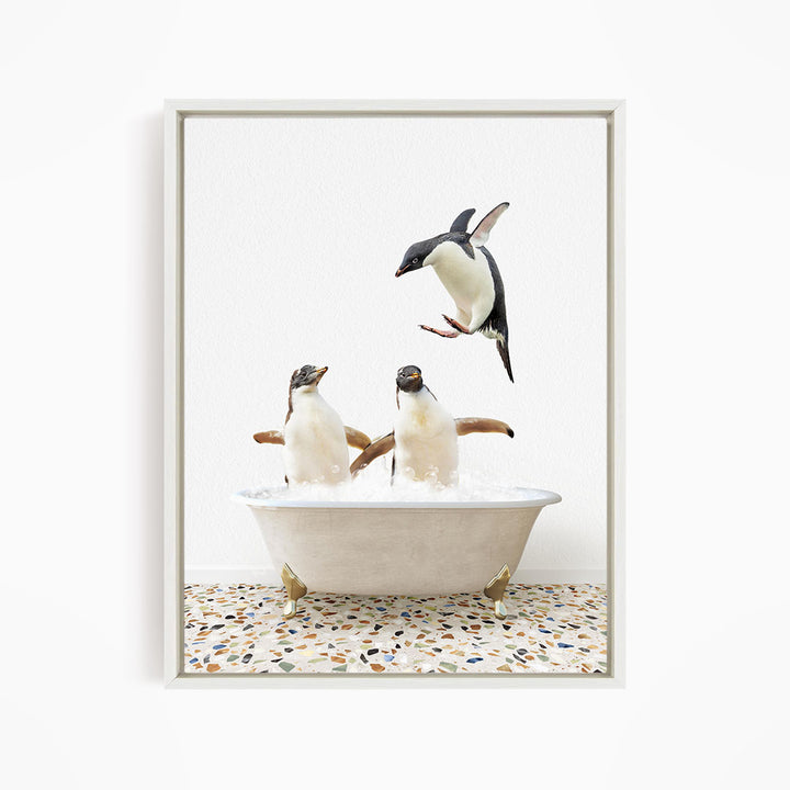 A framed image depicting two penguins standing in a bathtub filled with water, with one penguin flying towards the other.