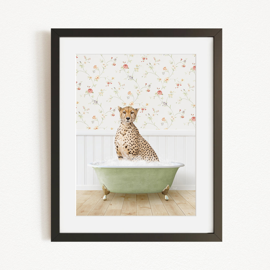 A cheetah sitting in a green bathtub filled with water, with a floral wallpaper in the background.
