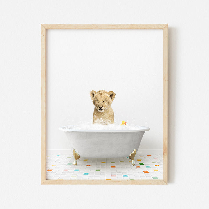 a framed photograph of a baby lion in a bathtub