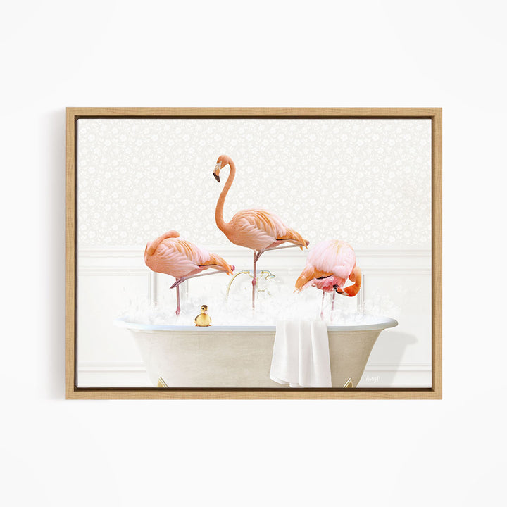 A framed image depicting three pink flamingos standing in a bathtub filled with water, with a towel and a small toy duck floating on the surface.